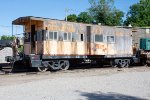 A bay window caboose sits in the Caney Fork & Western Yard 